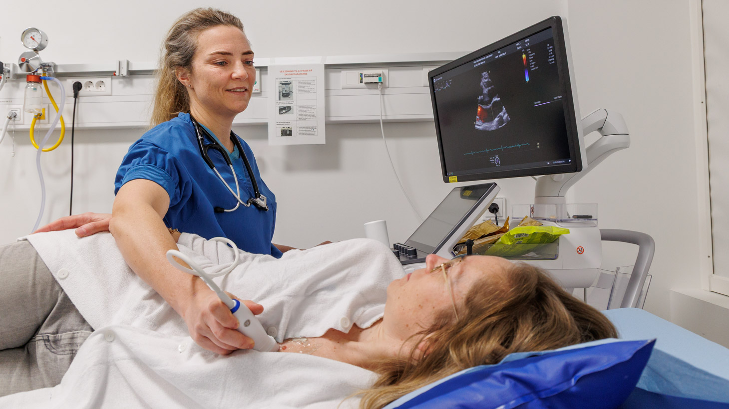 Patient ligger på et leje og får skannet hjertet