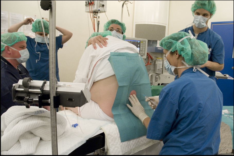 An anaesthesiologist administering a spinal anaesthetic